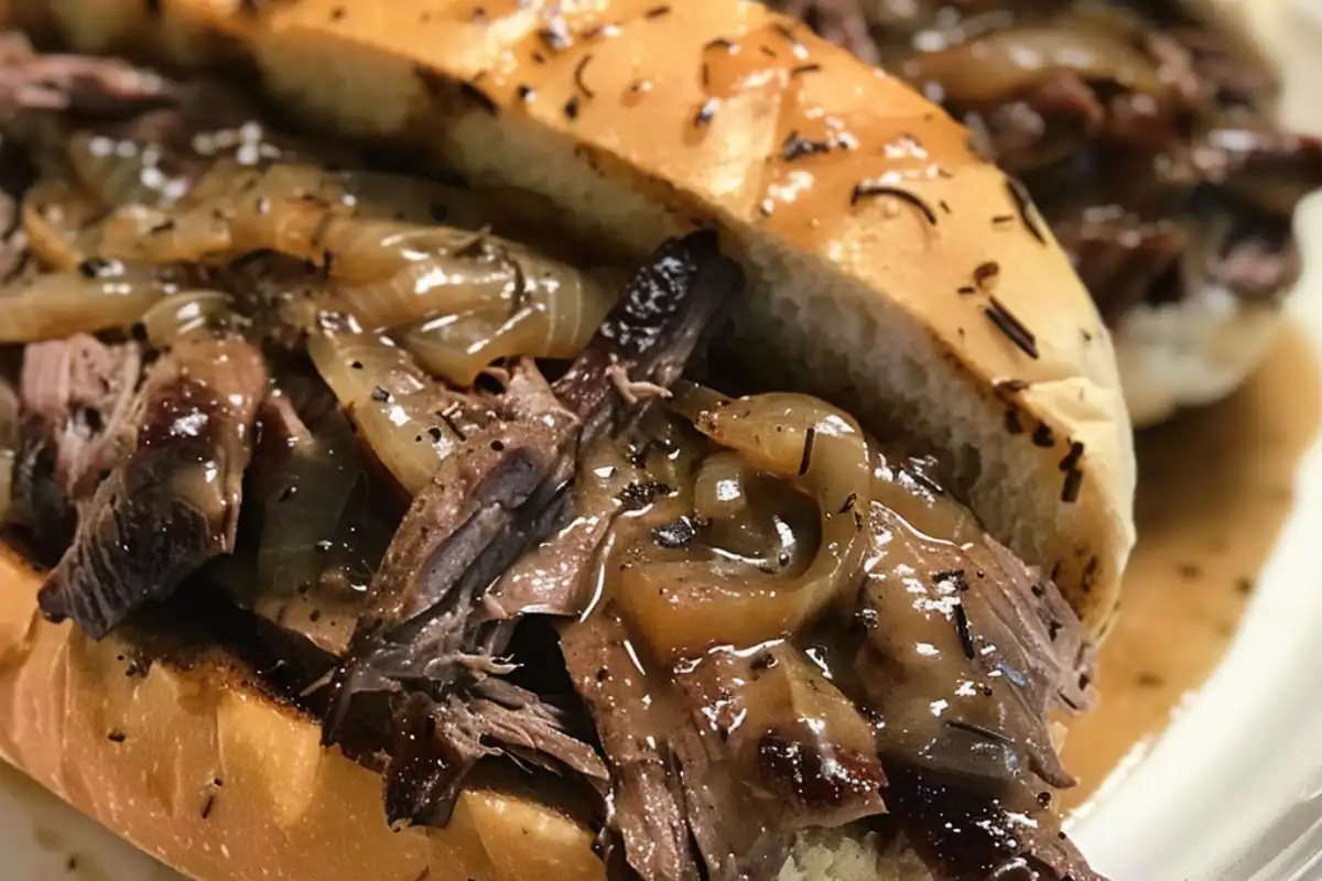 Crockpot French Dip Sandwich is made with tender beef, melted cheese, and au jus. An easy slow cooker classic you’ll crave again and again!