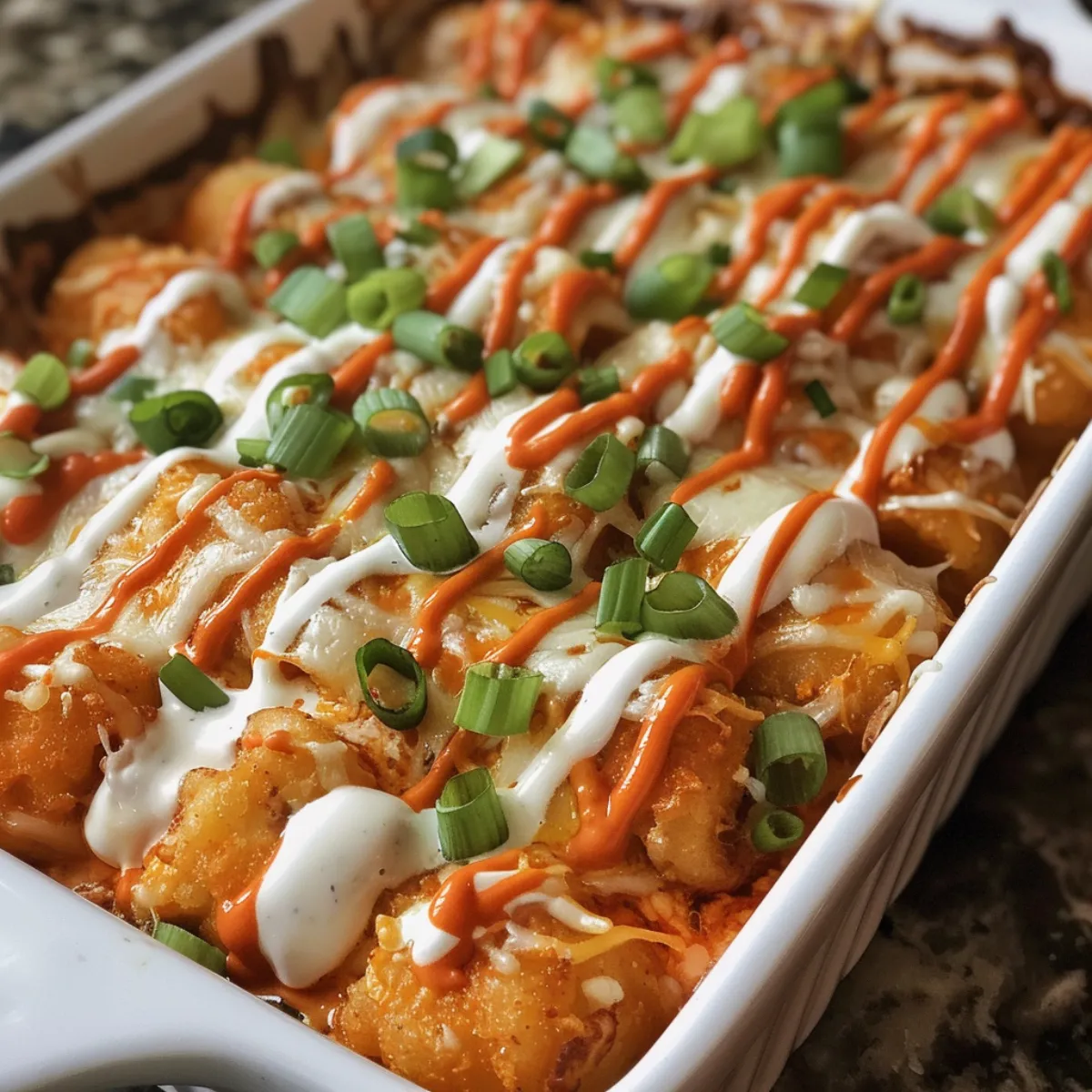 This Buffalo Chicken Tater Tot Casserole is cheesy, spicy, and loaded with buffalo chicken, ranch, and crispy tots. Perfect comfort food!