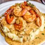 Creamy garlic shrimp over mashed potatoes is rich, comforting, and elegant—tender shrimp in a silky sauce atop fluffy, buttery potatoes!