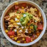 This easy chicken taco soup is bold, hearty, and ready in under 30 minutes! Packed with Tex-Mex flavor, beans, corn, and shredded chicken.