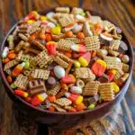 Whip up this Fall Halloween Buddy Mix in just 10 minutes! 🎃 A festive no-bake snack mix with Chex cereal, pretzels, candy corn, chocolates, and sprinkles. Perfect for Halloween parties!