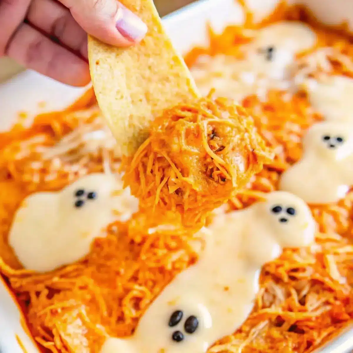 This Halloween Buffalo Chicken Dip is a cheesy, spicy, and festive party appetizer topped with spooky decorations for the ultimate Halloween snack!