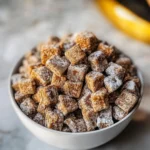 Butterfinger Puppy Chow is a no-bake snack mix with chocolate, peanut butter, and crushed Butterfingers. Quick, crunchy, and perfect for holidays or parties.
