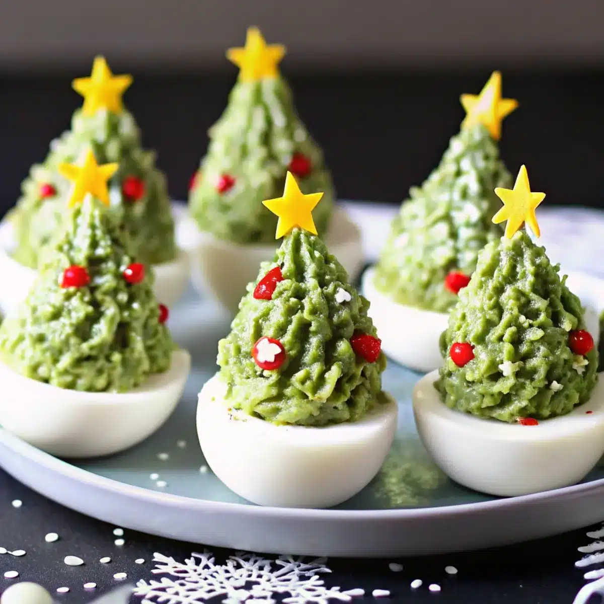 Turn classic deviled eggs into Christmas trees with avocado, herbs, and festive toppings. A fun and delicious holiday appetizer idea.