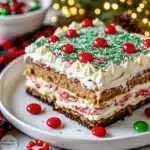 No-Bake Cookie Lasagna is a layered holiday dessert made with cookies, cheesecake, pudding, and whipped cream. Easy, festive, and perfect for Christmas gatherings!