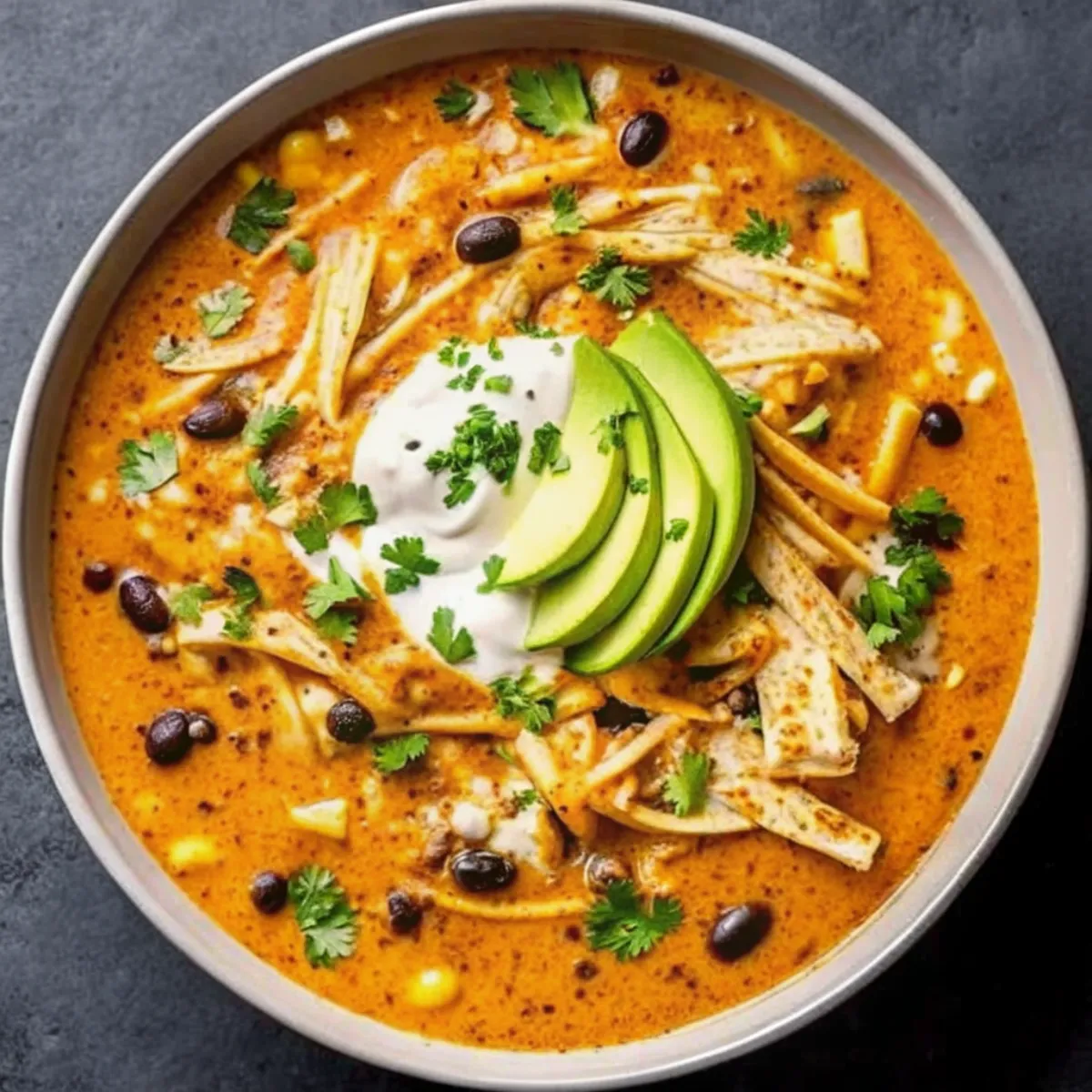 Chicken Tortilla Soup is a bold and hearty recipe made with shredded chicken, beans, corn, and spices in a savory broth.