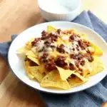 These Chili Nachos are loaded with warm chili, melted cheese, and crunchy chips—an easy, crowd-pleasing snack or appetizer. Make this Chili Nachos recipe for game day or quick meals in minutes.